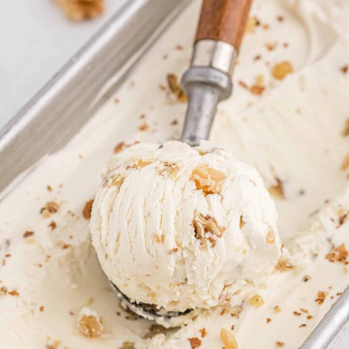 Maple walnut ice cream with a scoop in it.