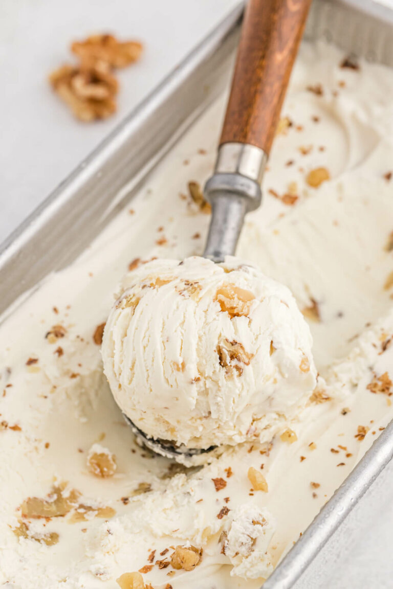 Maple walnut ice cream with a scoop in it.