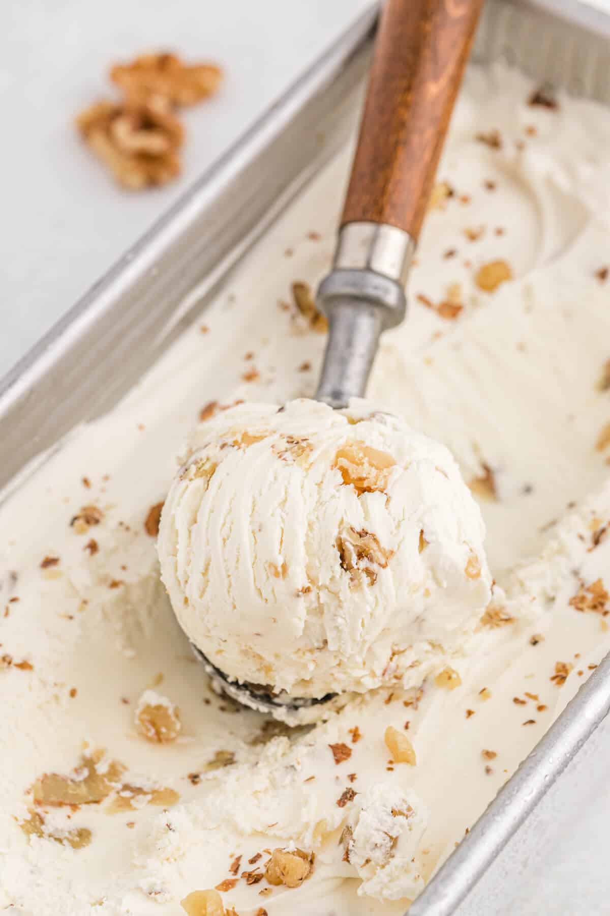 Maple walnut ice cream with a scoop in it.