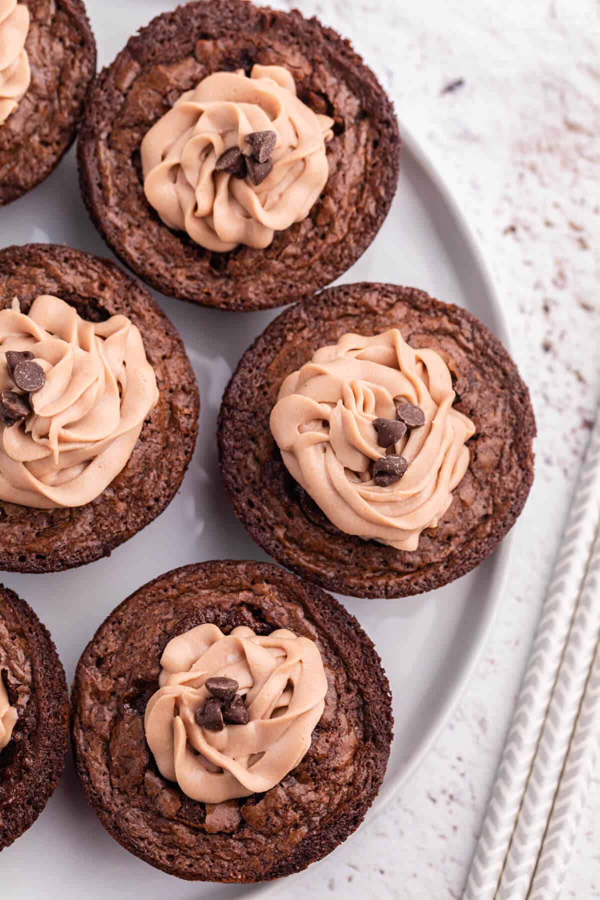 Brownie cheesecake cups on a plate.