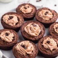 Brownie cheesecake cups on a plate.