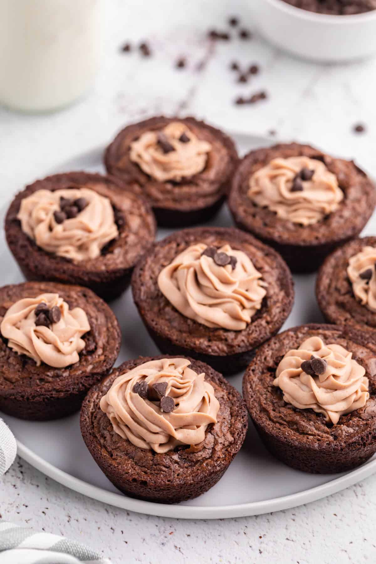 Brownie cheesecake cups on a plate.