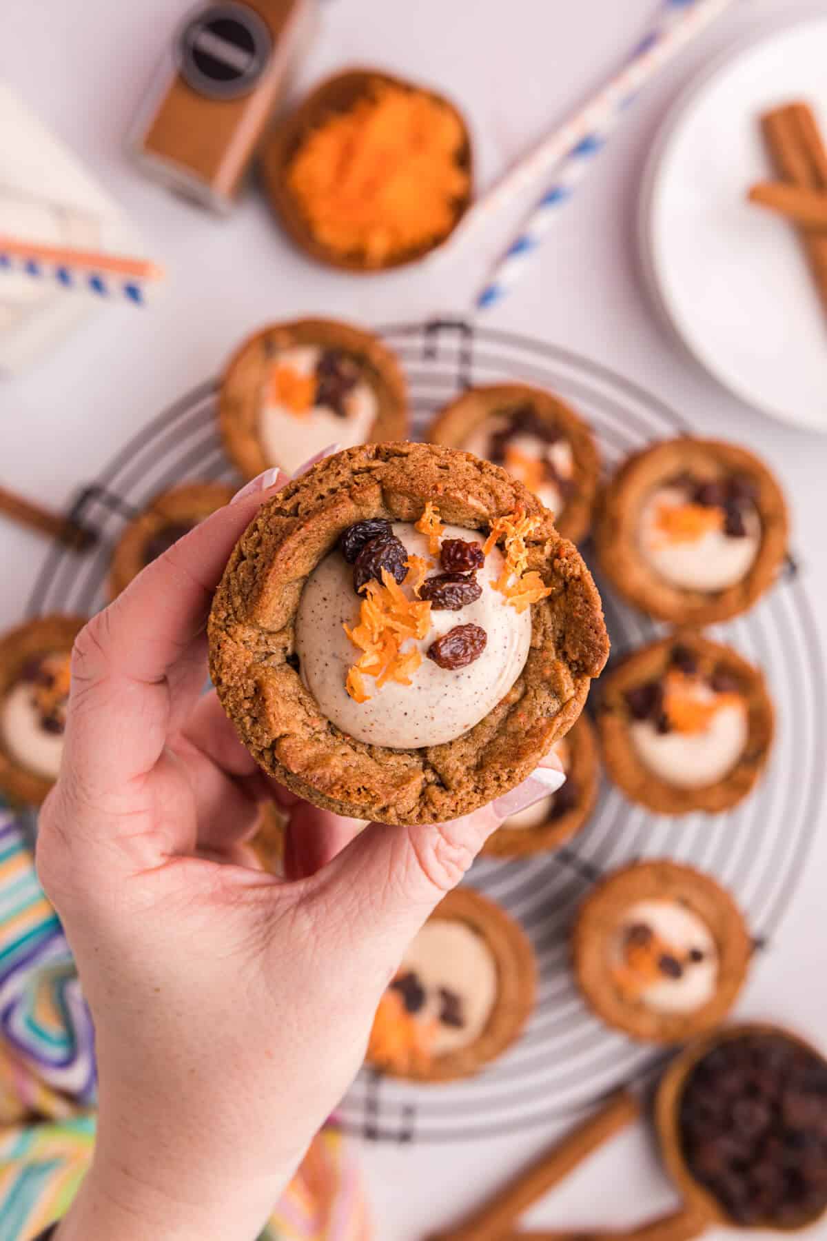 A hand holding a carrot cake cup.