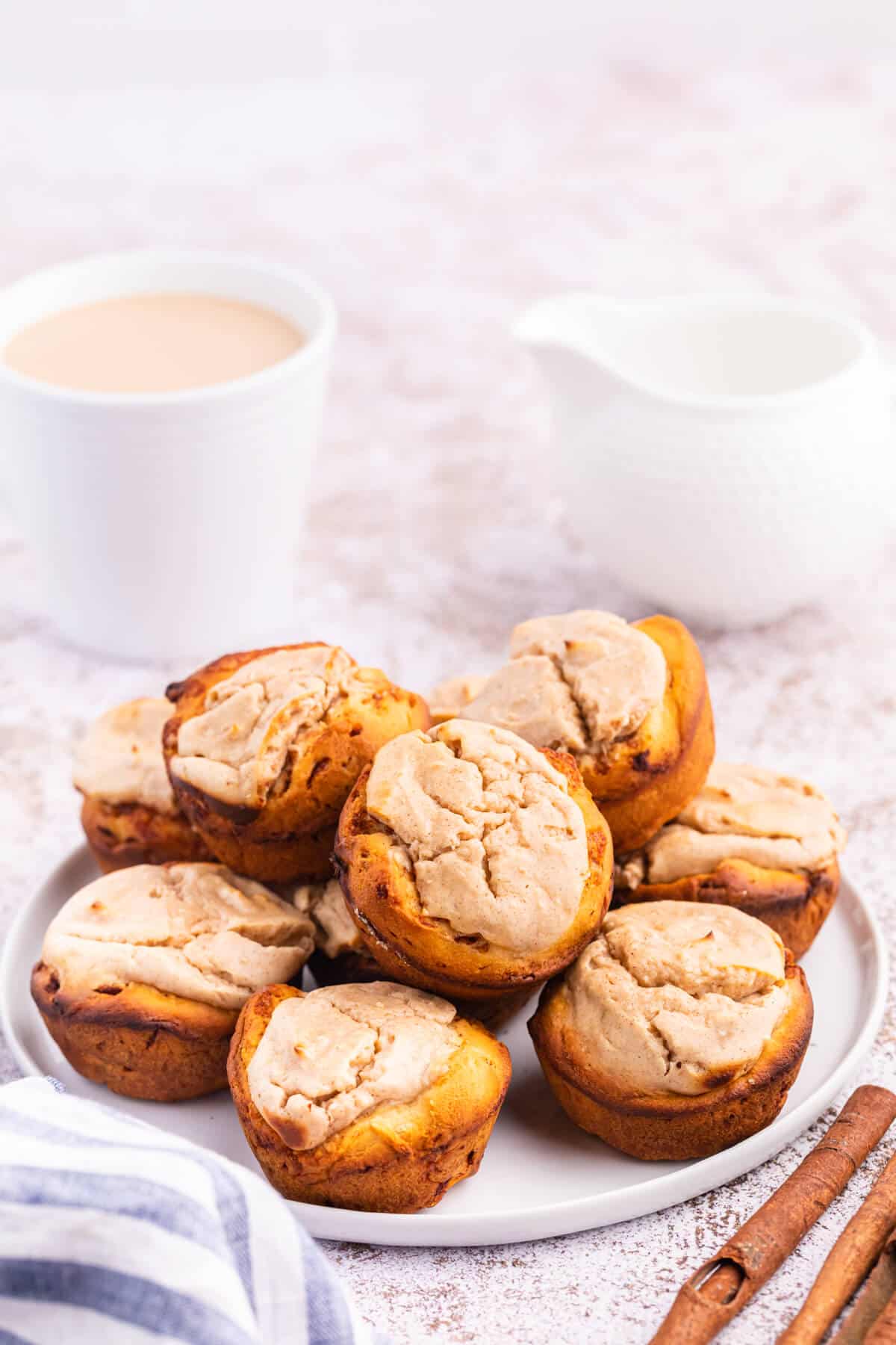 Cheesecake stuffed cinnamon rolls on a plate.