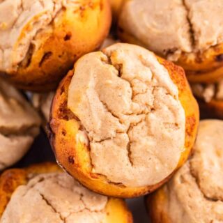 Close up of cheesecake stuffed cinnamon rolls on a plate.