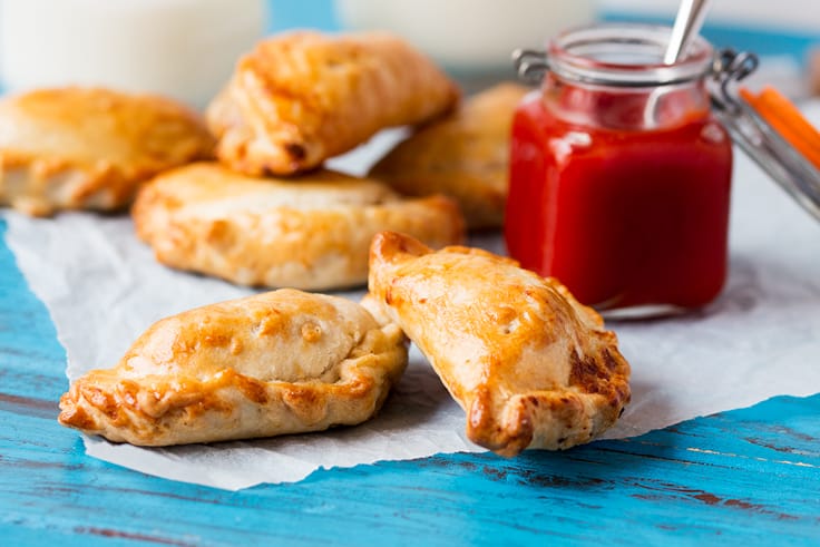 Cheese and Bacon Hand Pies - Hearty and comforting! These handheld meat pies are stuffed with bacon and cheese for a savory treat at any meal.