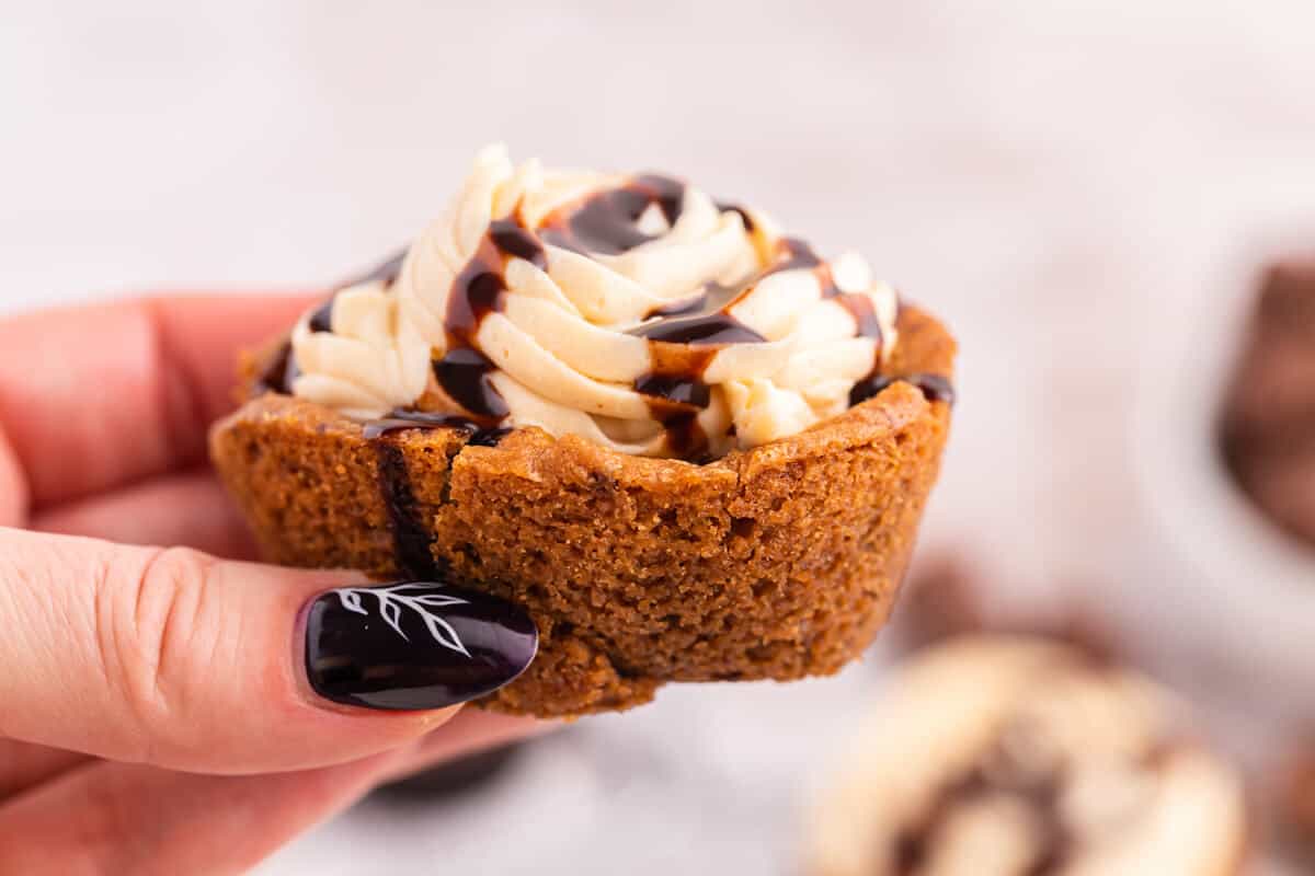 A hand holding a Reese's Cookie Cup.