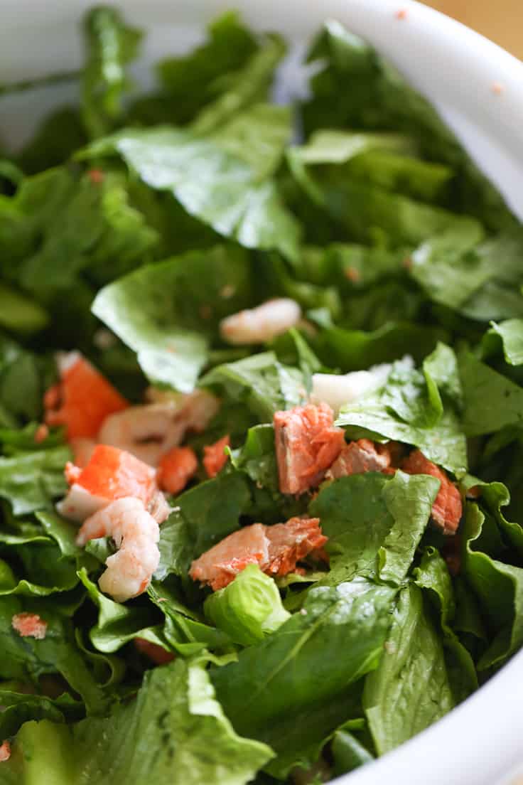 Seafood Caesar Salad - With salmon, shrimp and crab packed into every bite, seafood fans are in for a real treat with this delicious recipe for Seafood Caesar Salad.