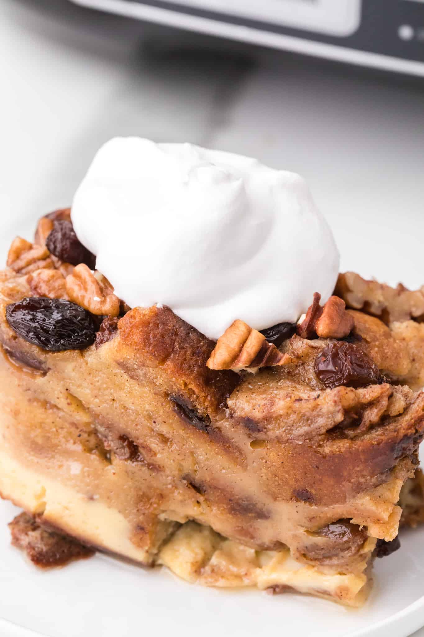 A piece of cinnamon raisin bread pudding on plate.