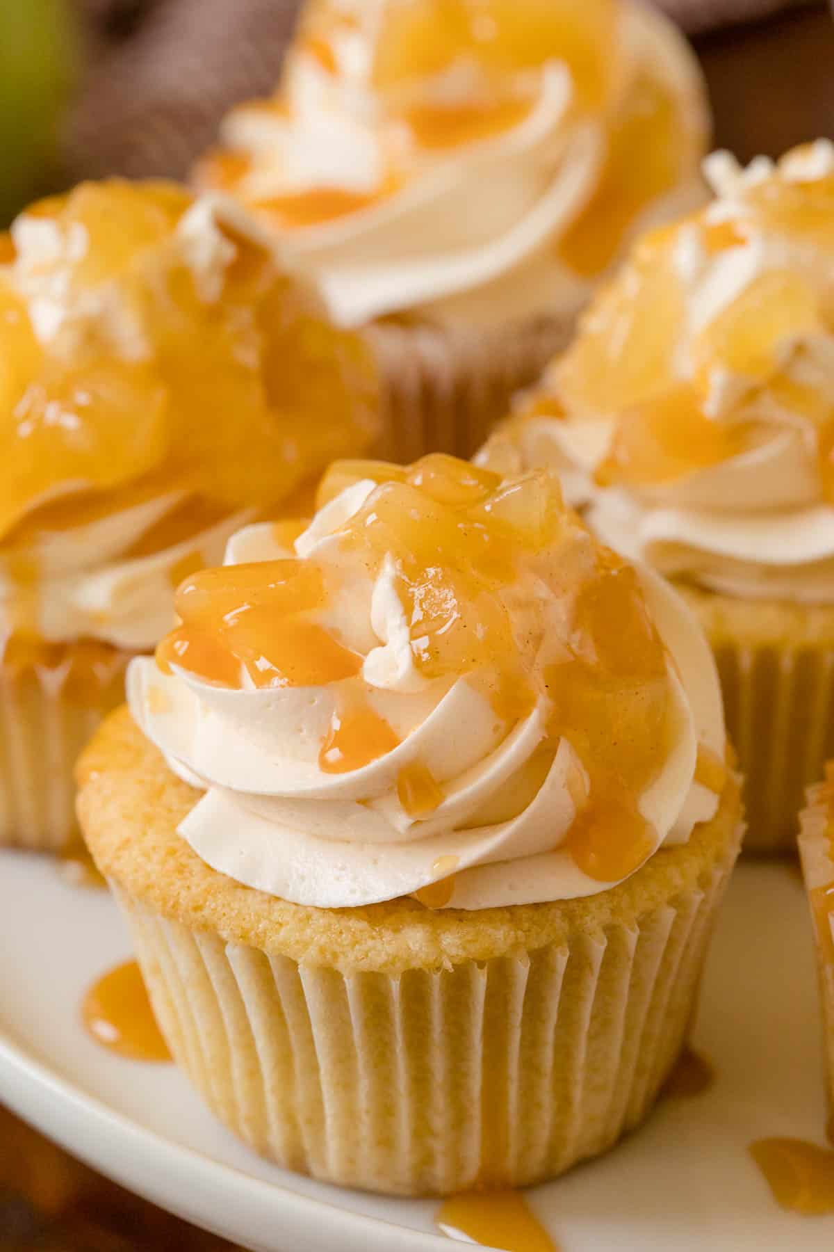 Caramel Apple Cupcakes - Fall in a cupcake! Sweet caramel and apple pie are packed into this delicious handheld dessert.