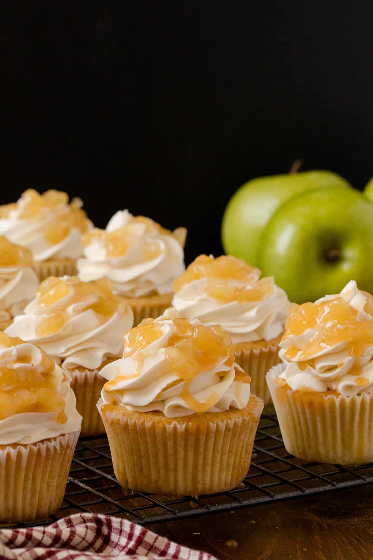 Caramel Apple Cupcakes - Fall in a cupcake! Sweet caramel and apple pie are packed into this delicious handheld dessert.