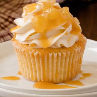 Caramel Apple Cupcakes - Fall in a cupcake! Sweet caramel and apple pie are packed into this delicious handheld dessert.