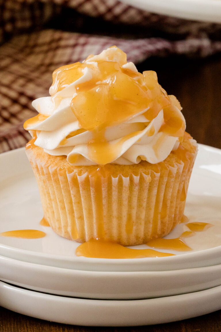 Caramel Apple Cupcakes - Fall in a cupcake! Sweet caramel and apple pie are packed into this delicious handheld dessert.