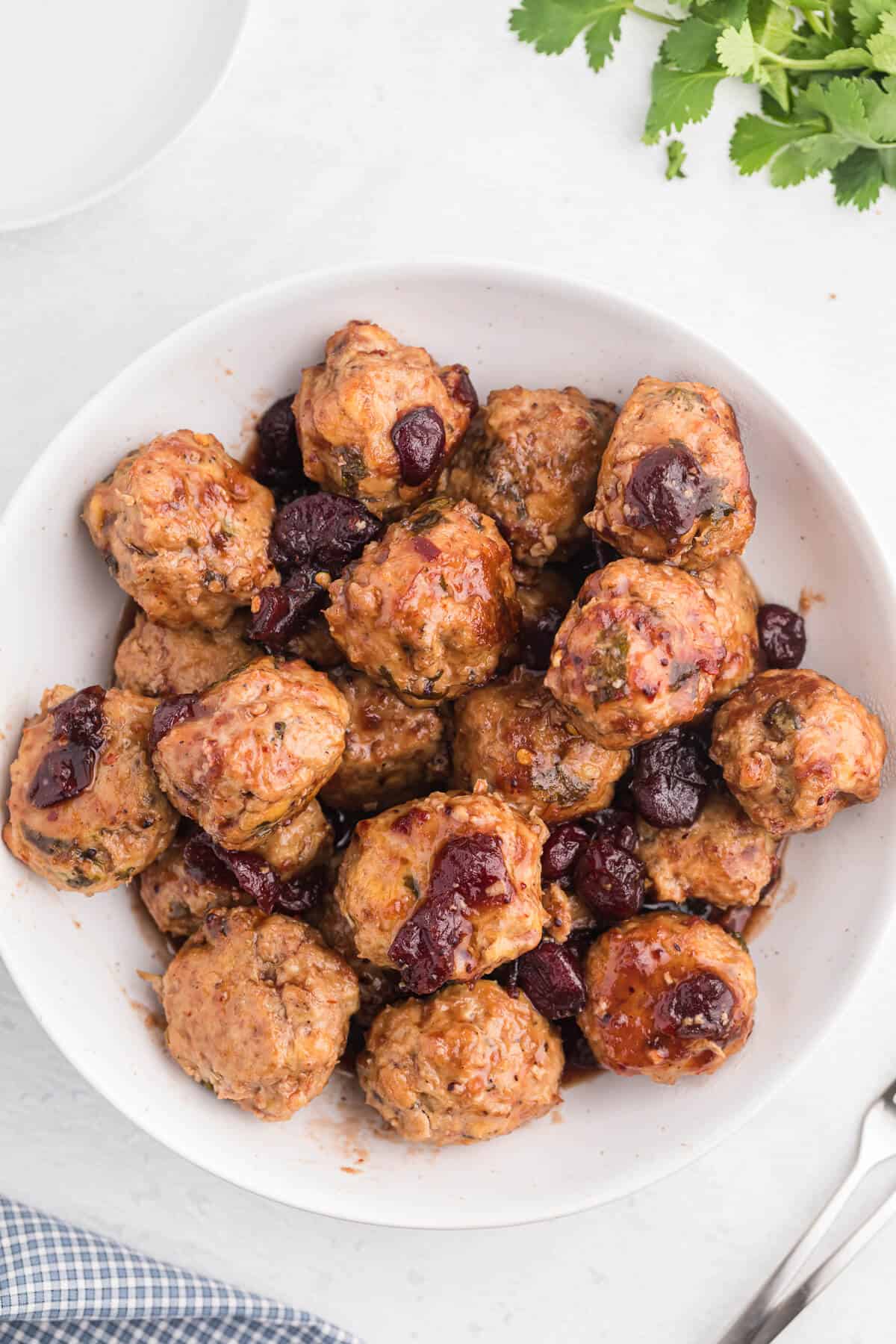 Chili Cranberry Fusion Meatballs - A delicious holiday appetizer! The comforting flavors of cranberry and chili combine for these slow cooker chicken meatballs.