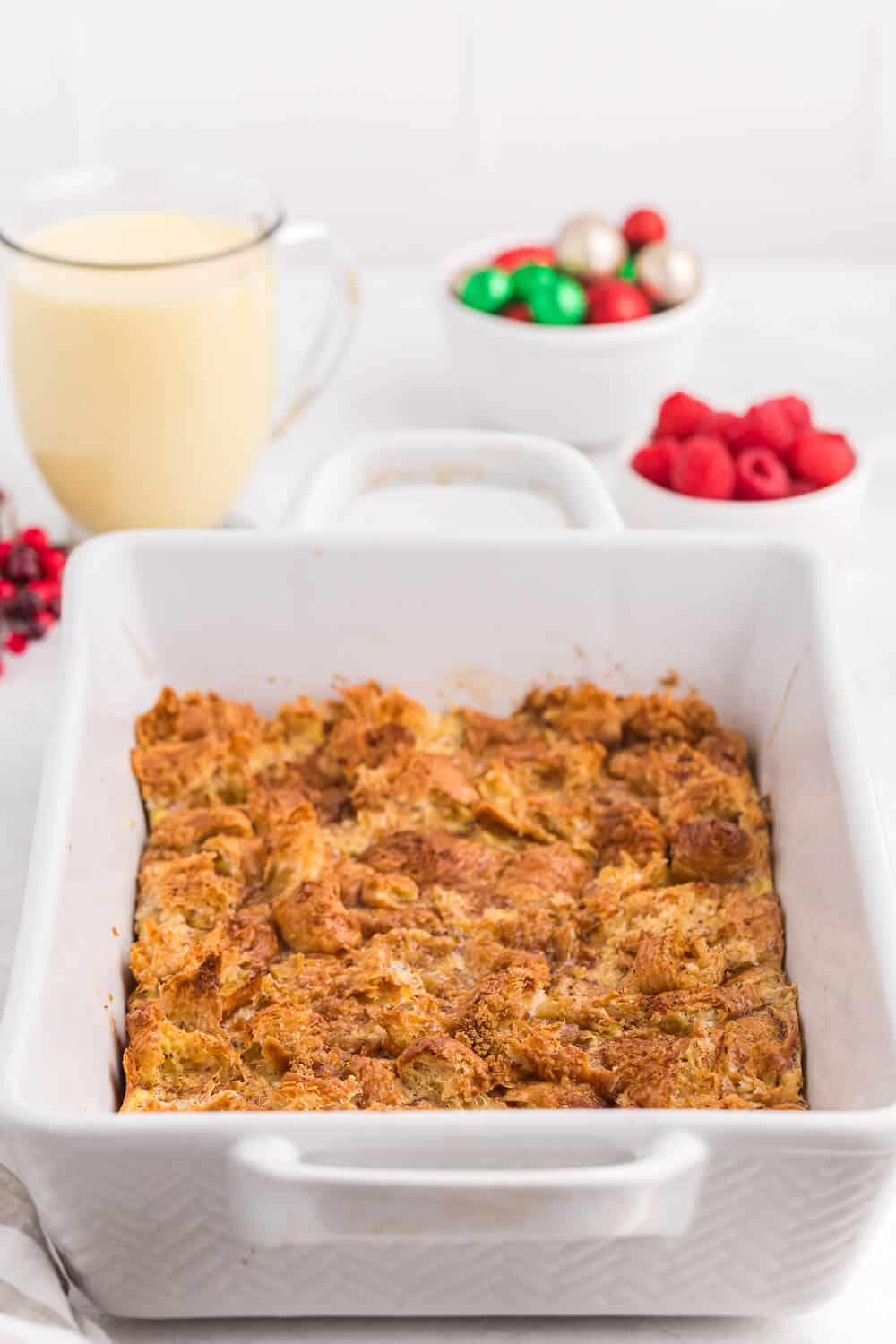Eggnog breakfast casserole in a white casserole.