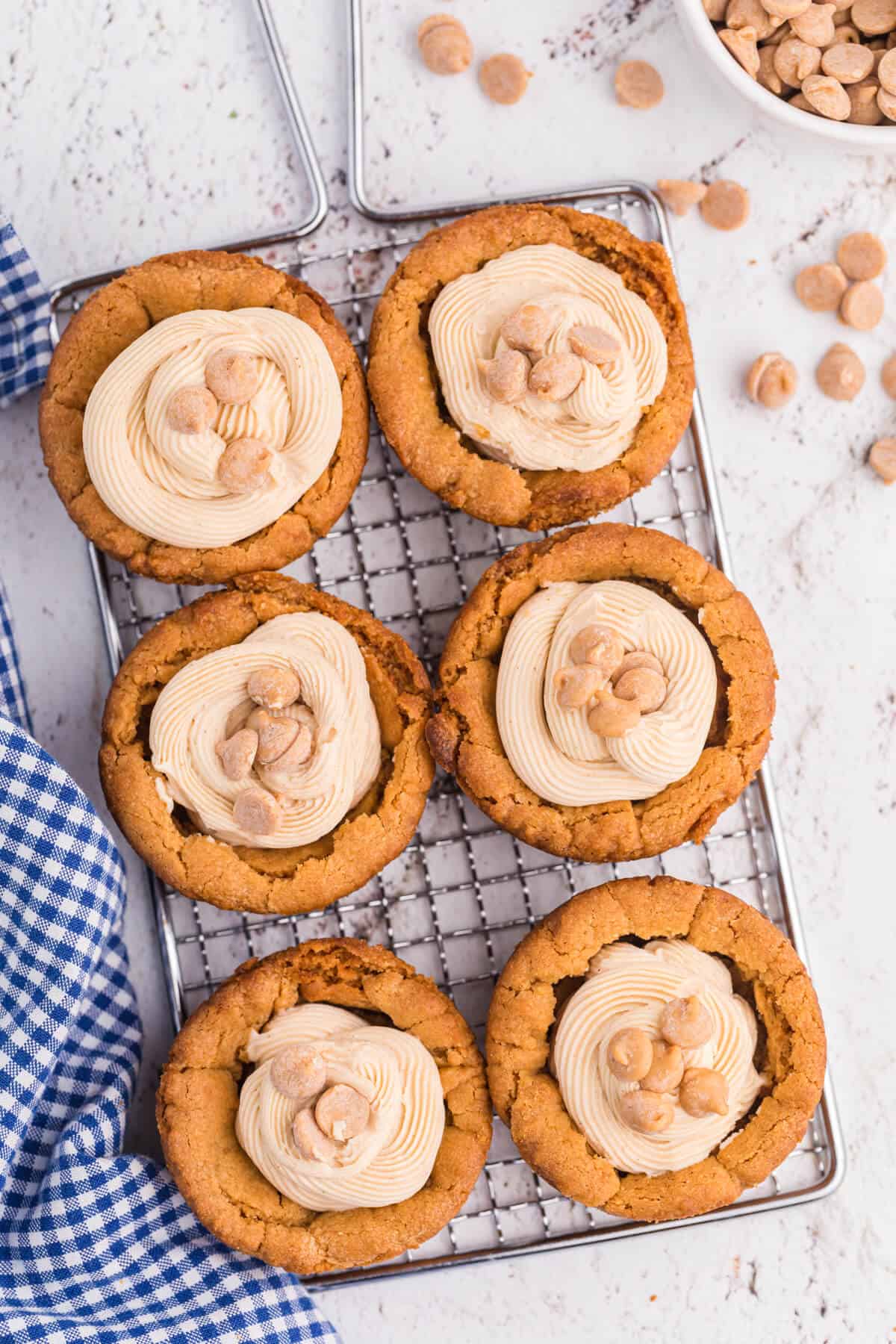 Peanut butter cookie cups on a wire rack.