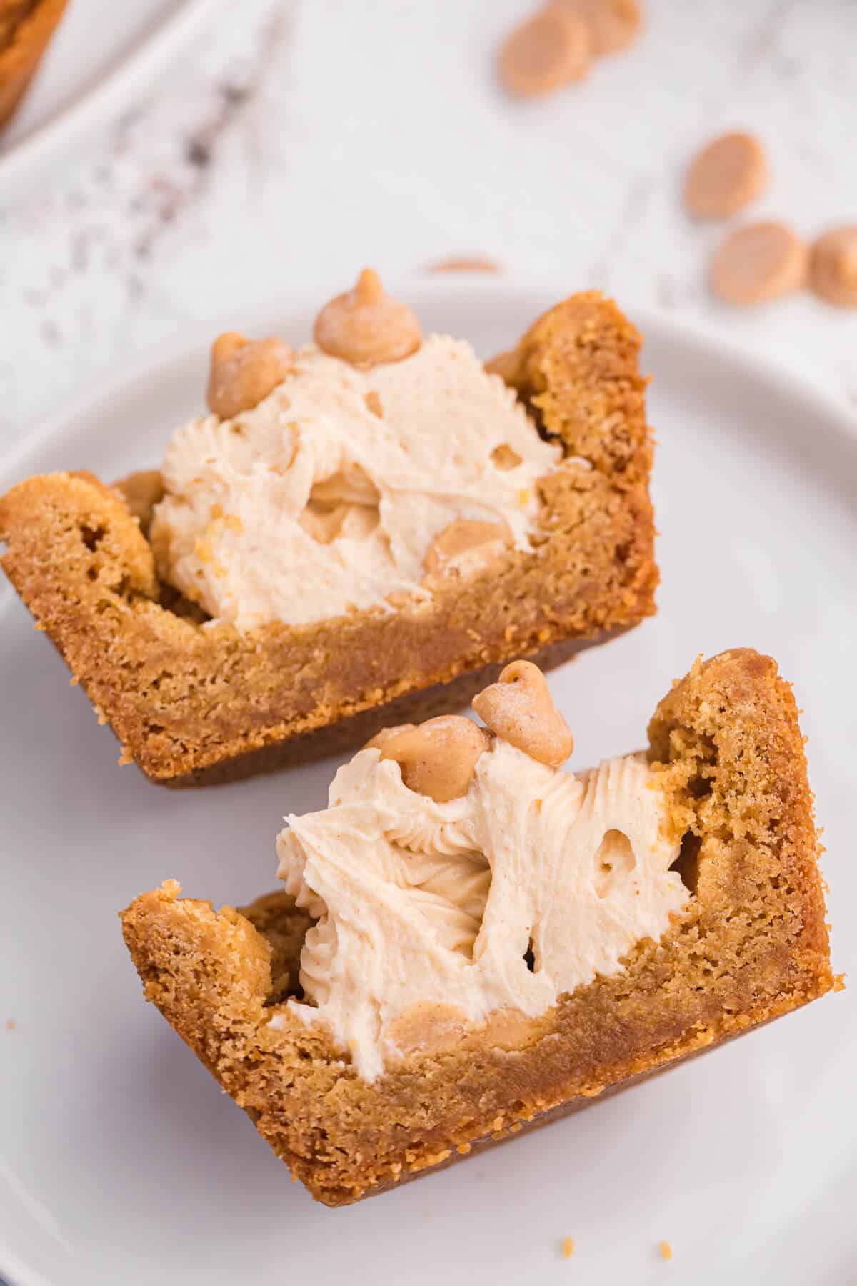 A peanut butter cookie cup cut in half on a plate.