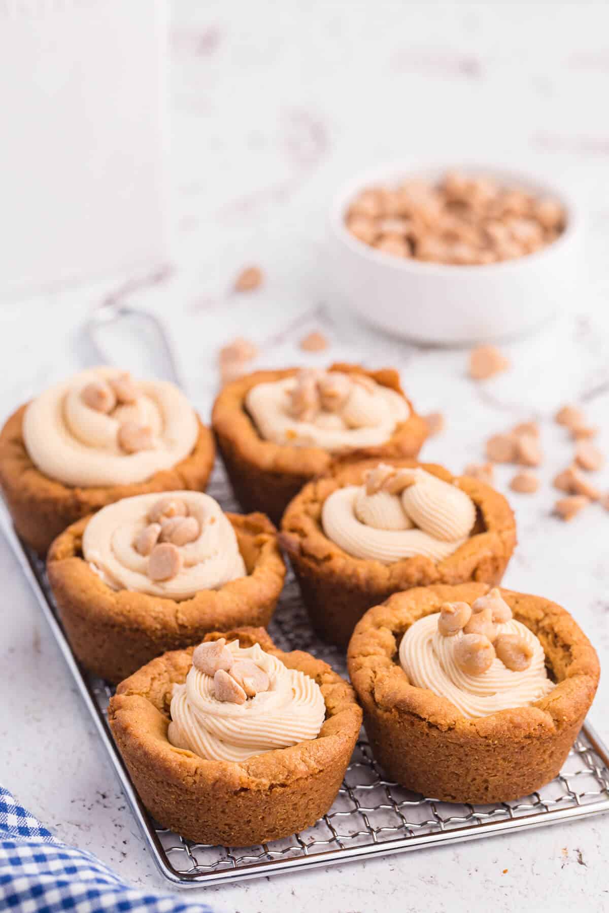 Peanut butter cookie cups on a wire rack.