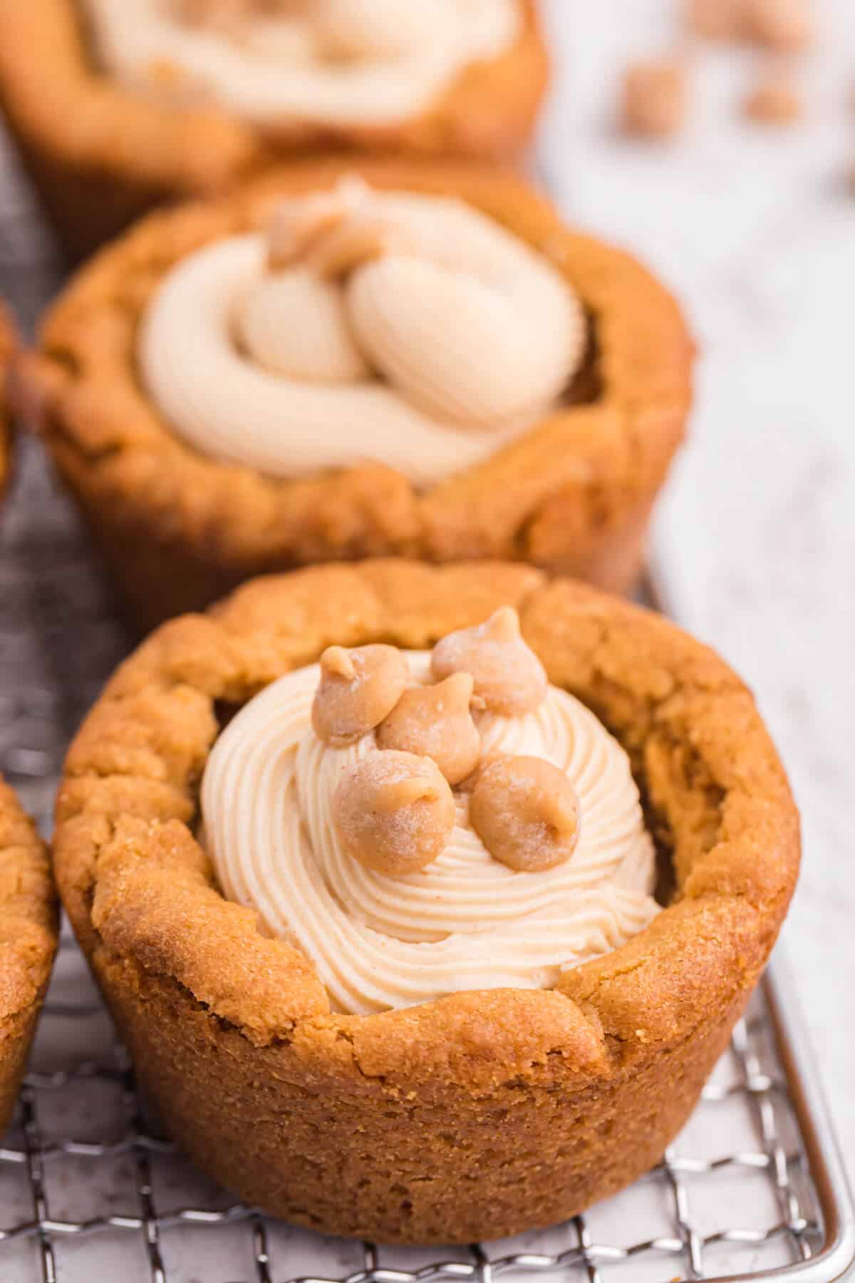 Peanut butter cookie cups on a wire rack.