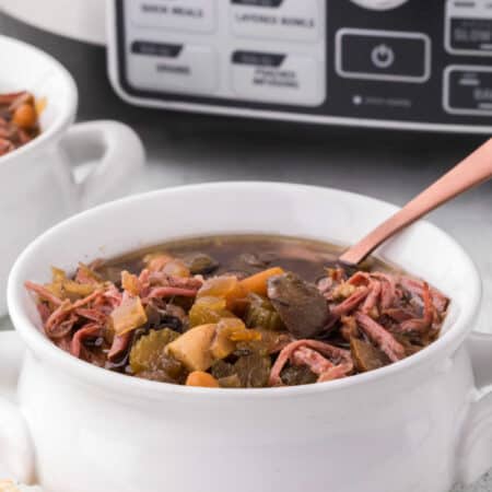 Beef brisket soup in a bowl with a spoon.