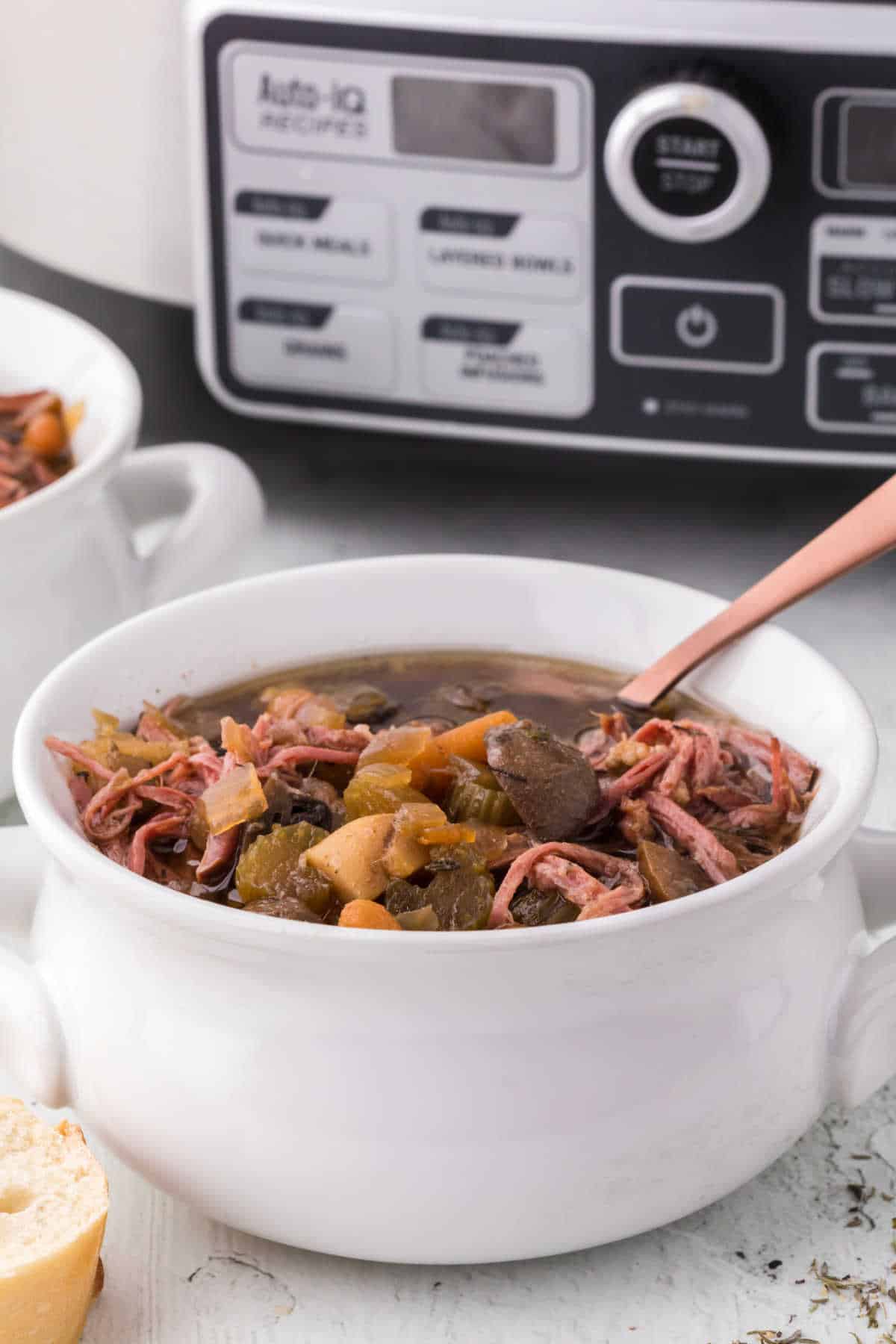 Beef brisket soup in a bowl with a spoon.