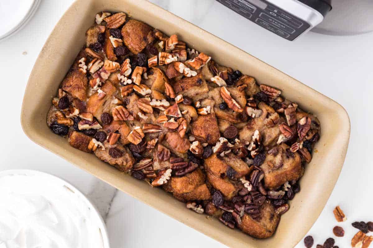 Cinnamon raisin bread pudding in a loaf pan.