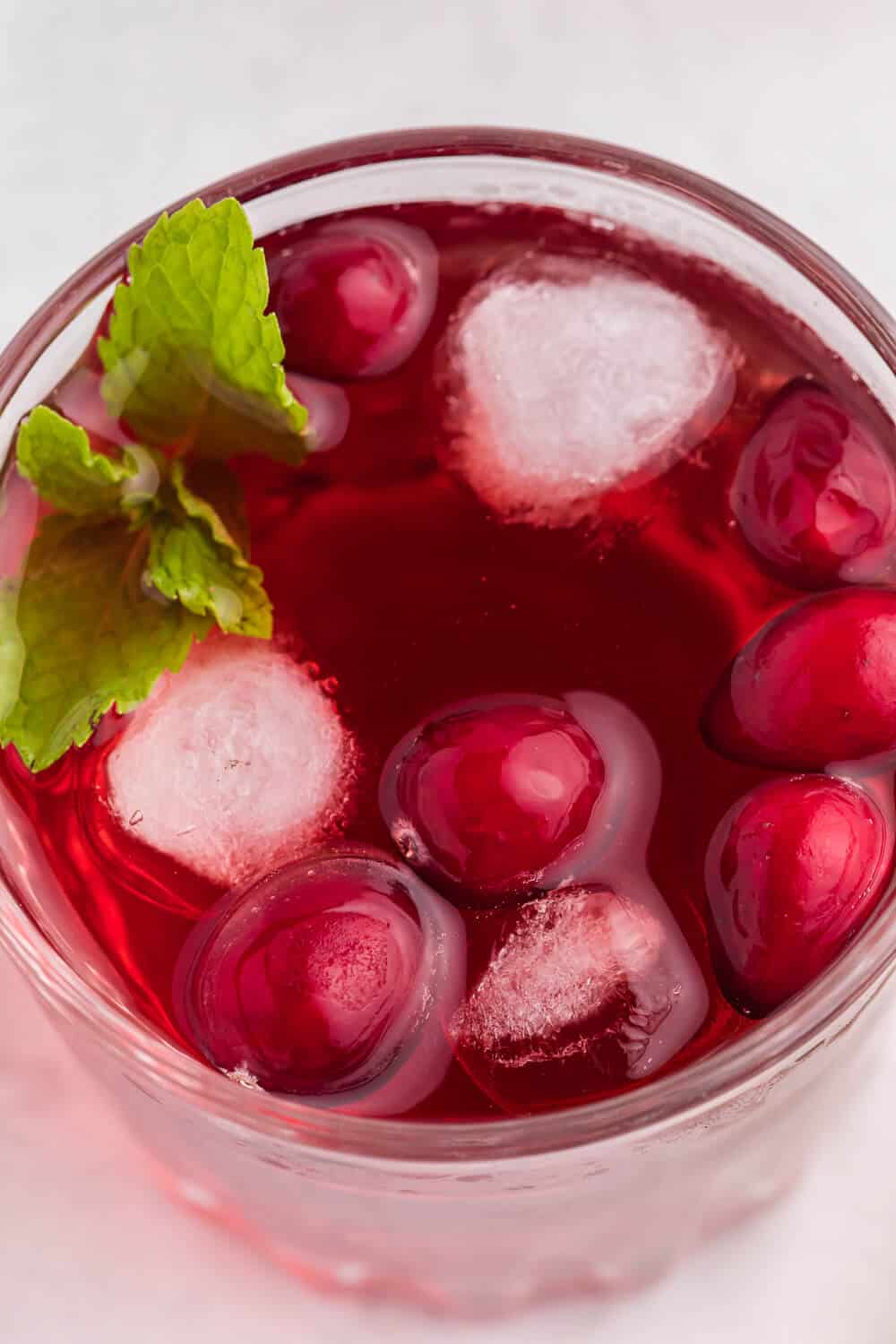 Cranberry Mint Mocktail - This mocktail is the perfect holiday party beverage. The red cranberries and green mint echo the colours of the season, with a sweet, refreshing and bubbly tang!