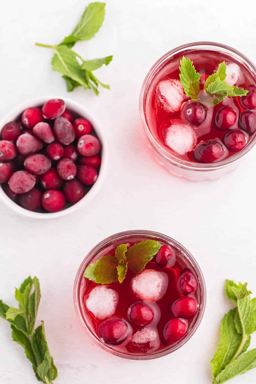 Cranberry Mint Mocktail - This mocktail is the perfect holiday party beverage. The red cranberries and green mint echo the colours of the season, with a sweet, refreshing and bubbly tang!