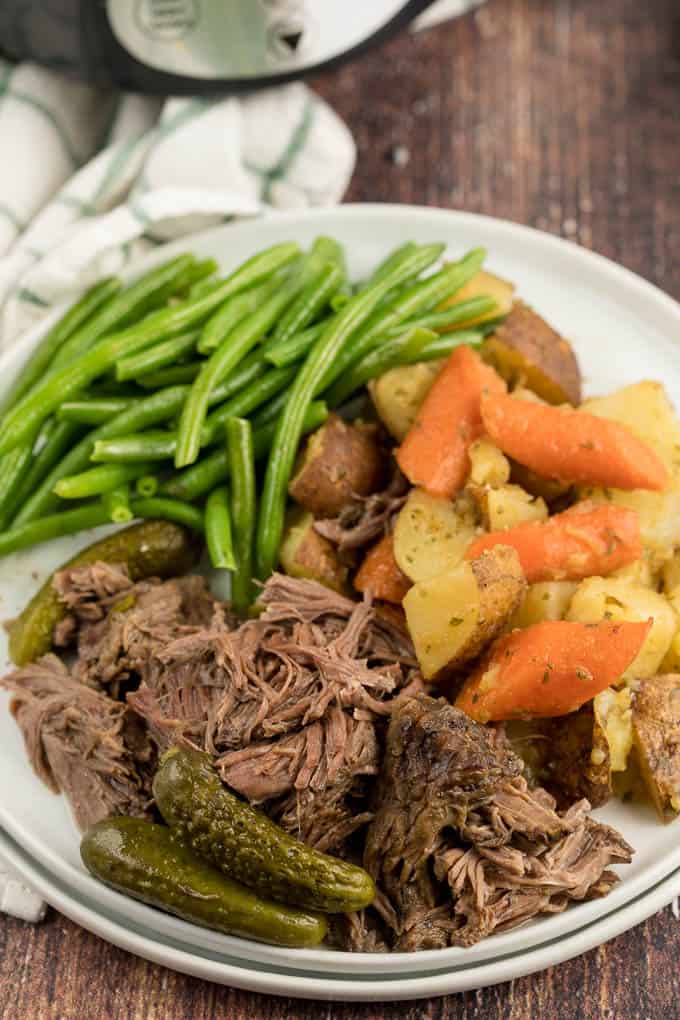 Dill Pickle Roast Beef - This might be the most simple slow cooker recipe ever! Dump a jar of pickles in a slow cooker with your preferred cut of beef. You'll be amazed in 8 hours!