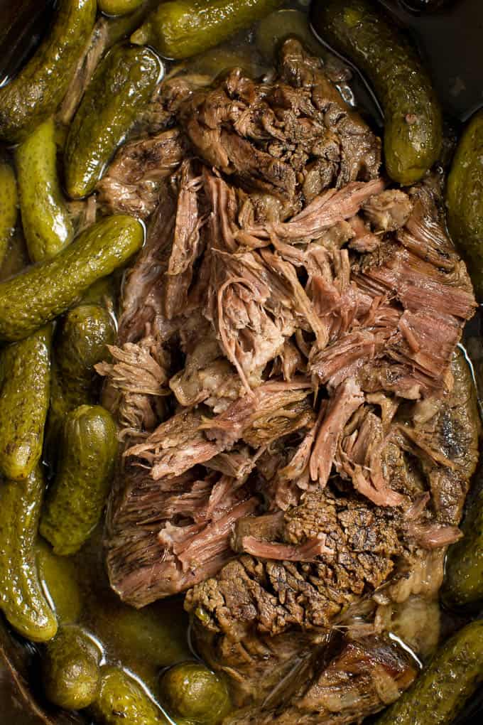 Dill Pickle Roast Beef - This might be the most simple slow cooker recipe ever! Dump a jar of pickles in a slow cooker with your preferred cut of beef. You'll be amazed in 8 hours!