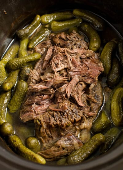 Dill Pickle Roast Beef - This might be the most simple slow cooker recipe ever! Dump a jar of pickles in a slow cooker with your preferred cut of beef. You'll be amazed in 8 hours!