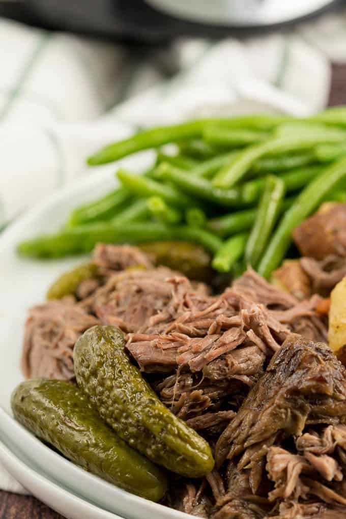 Dill Pickle Roast Beef - This might be the most simple slow cooker recipe ever! Dump a jar of pickles in a slow cooker with your preferred cut of beef. You'll be amazed in 8 hours!