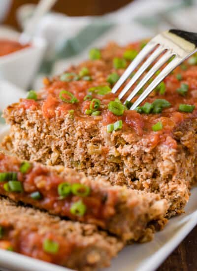 Mexican Meatloaf - A spicy twist on a classic recipe! This Mexican Meatloaf is packed with beef, cheese, seasonings, chilies and salsa. The results is a mouthwatering meal!