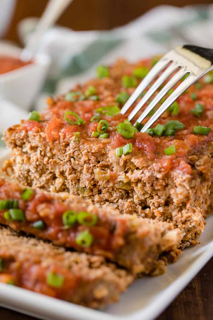 Mexican Meatloaf - A spicy twist on a classic recipe! This Mexican Meatloaf is packed with beef, cheese, seasonings, chilies and salsa. The results is a mouthwatering meal!