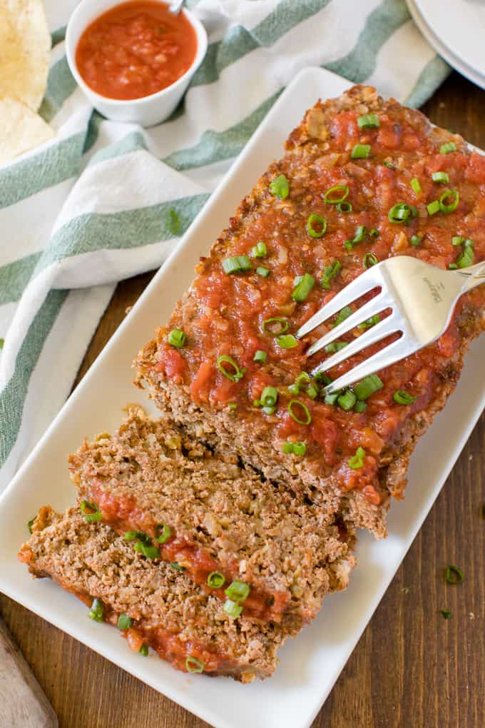 Mexican Meatloaf - A classic recipe with a spicy twist! Beef, cheese, seasonings, chilies and salsa results in a mouthwatering meal.