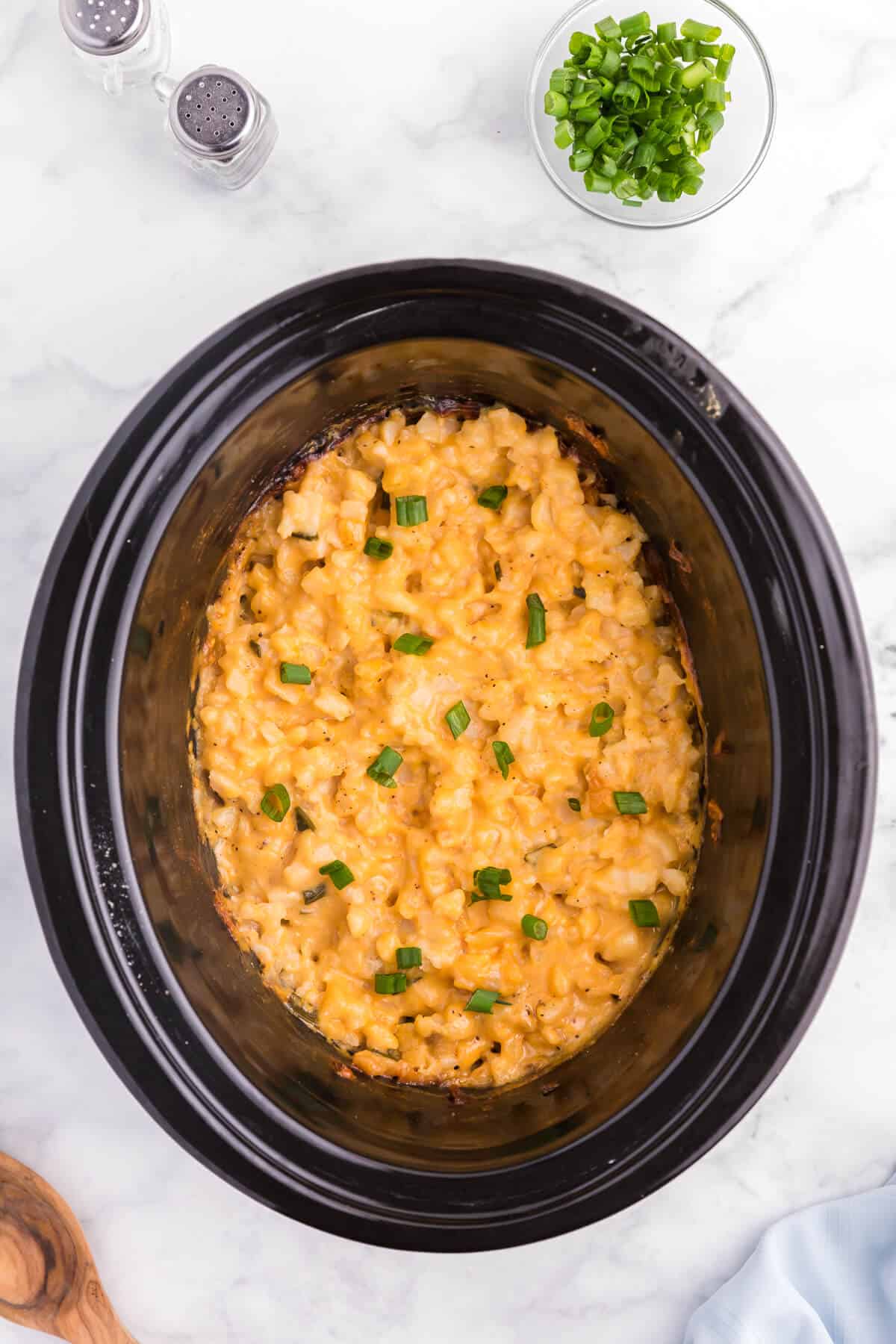 Slow Cooker Cheesy Potatoes - The creamiest potato recipe! Grab your Crockpot for this 4-ingredient side dish with frozen hash browns, cheese soup, and evaporated milk.