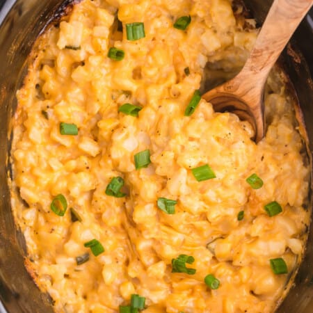 Slow Cooker Cheesy Potatoes is a delicious and hearty side dish to pair with your weeknight dinner. Frozen hash browns, canned cheese soup and a few other ingredients are all you need for this easy potato recipe.