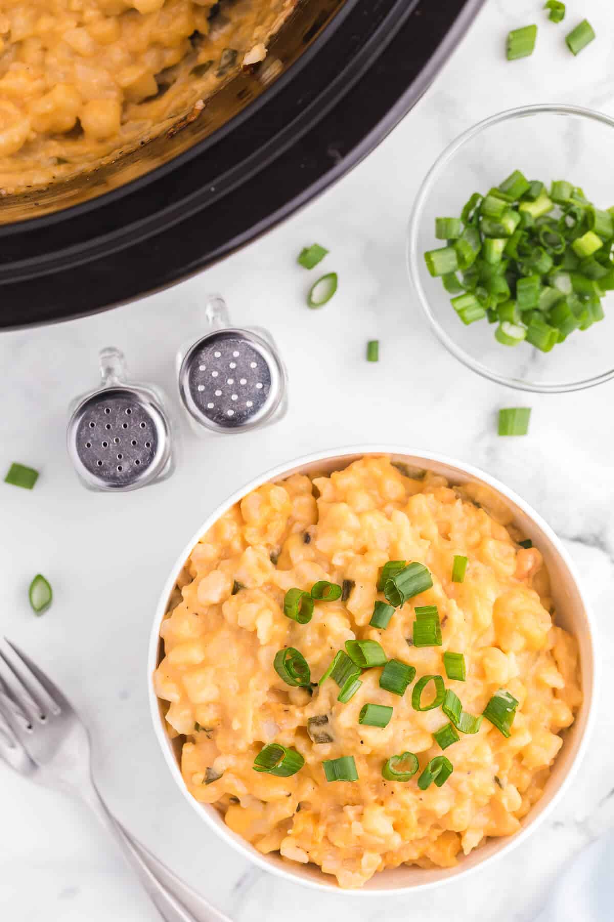 Slow Cooker Cheesy Potatoes - The creamiest potato recipe! Grab your Crockpot for this 4-ingredient side dish with frozen hash browns, cheese soup, and evaporated milk.