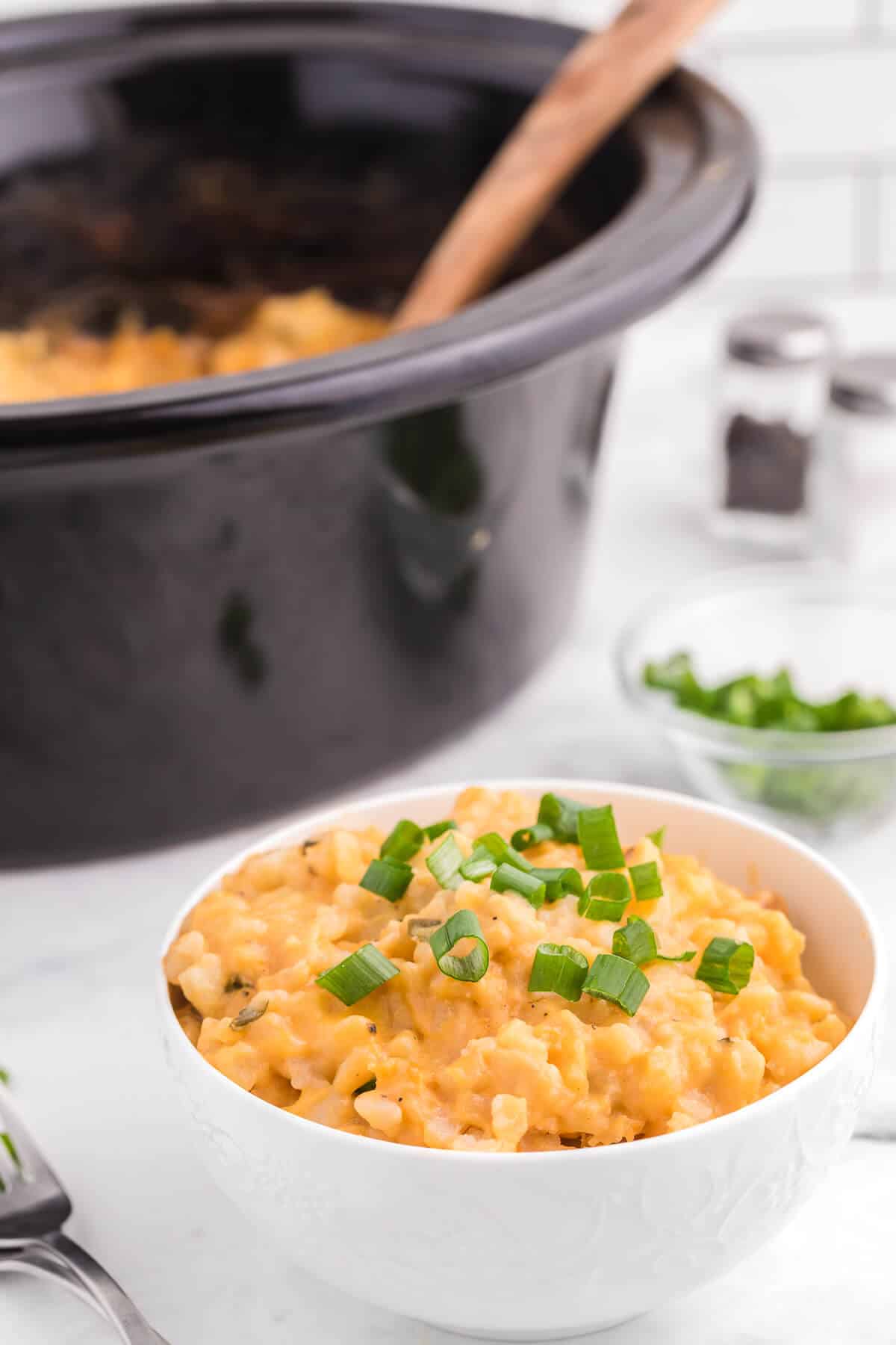 Slow Cooker Cheesy Potatoes - The creamiest potato recipe! Grab your Crockpot for this 4-ingredient side dish with frozen hash browns, cheese soup, and evaporated milk.