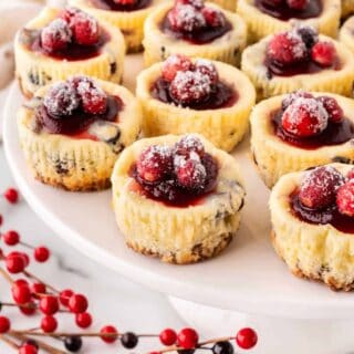 Cranberry white chocolate cheesecake on a platter.