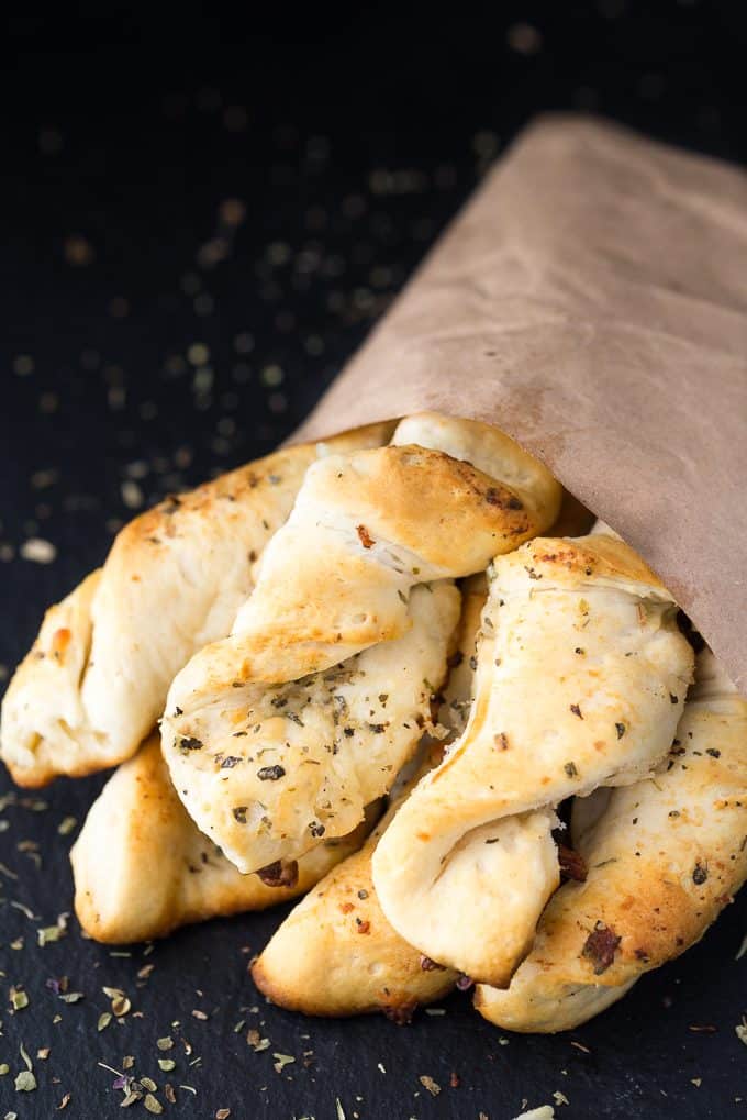 Easy Garlic Twists - The easiest garlic bread! Take those canned biscuits and make the best savory side dish with butter, Italian seasoning, Parmesan, and mozzarella.