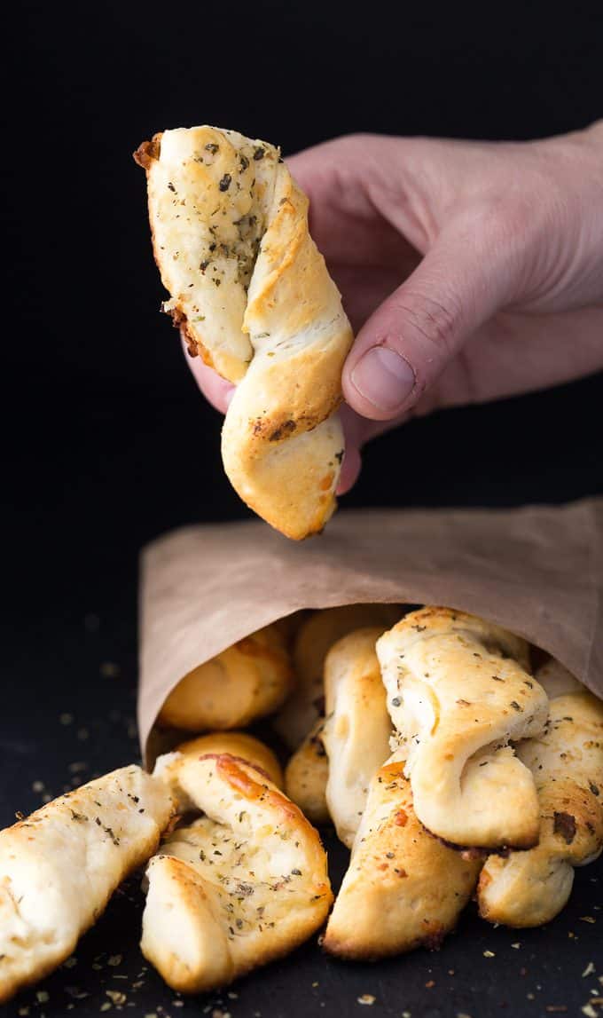 Easy Garlic Twists - The easiest garlic bread! Take those canned biscuits and make the best savory side dish with butter, Italian seasoning, Parmesan, and mozzarella.