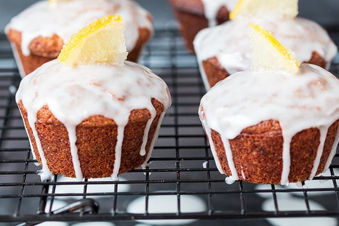 Lemon Drizzle Muffins - Zesty lemon muffins, topped with a lemon glaze and finished off with little slices of sugared lemons. Yum!