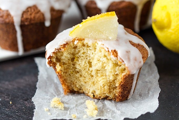 Lemon Drizzle Muffins - Zesty lemon muffins, topped with a lemon glaze and finished off with little slices of sugared lemons. Yum!