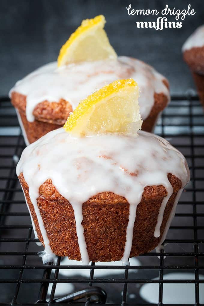 Lemon Drizzle Muffins - Zesty lemon muffins, topped with a lemon glaze and finished off with little slices of sugared lemons. Yum!