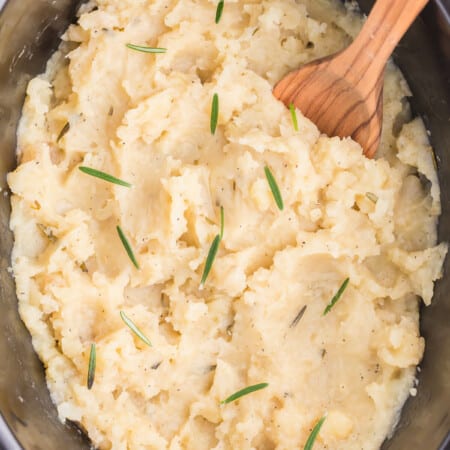 Slow Cooker Rosemary Garlic Mashed Potatoes are the best way to make potatoes. Creamy, rich, garlicky flavor in every bite.