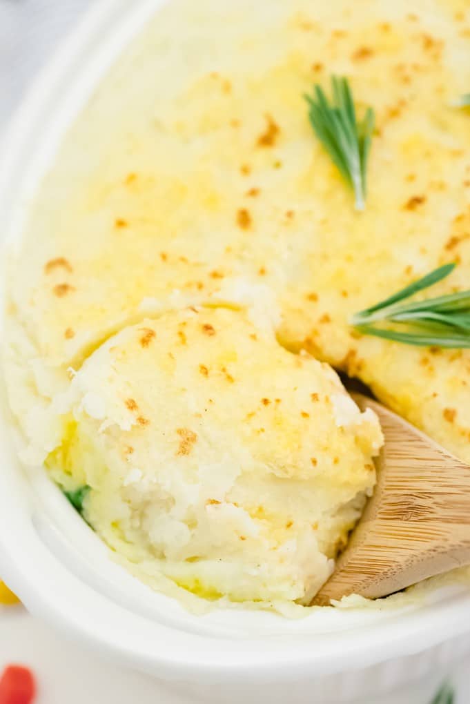 Chicken Shepherd's Pie - Not your mama's Shepherd Pie! This version is made with a creamy curry sauce that is out of this world. Topped with a heavenly layer of mashed potatoes and Parmesan cheese, this comfort food recipe will not last long. Mmm good.