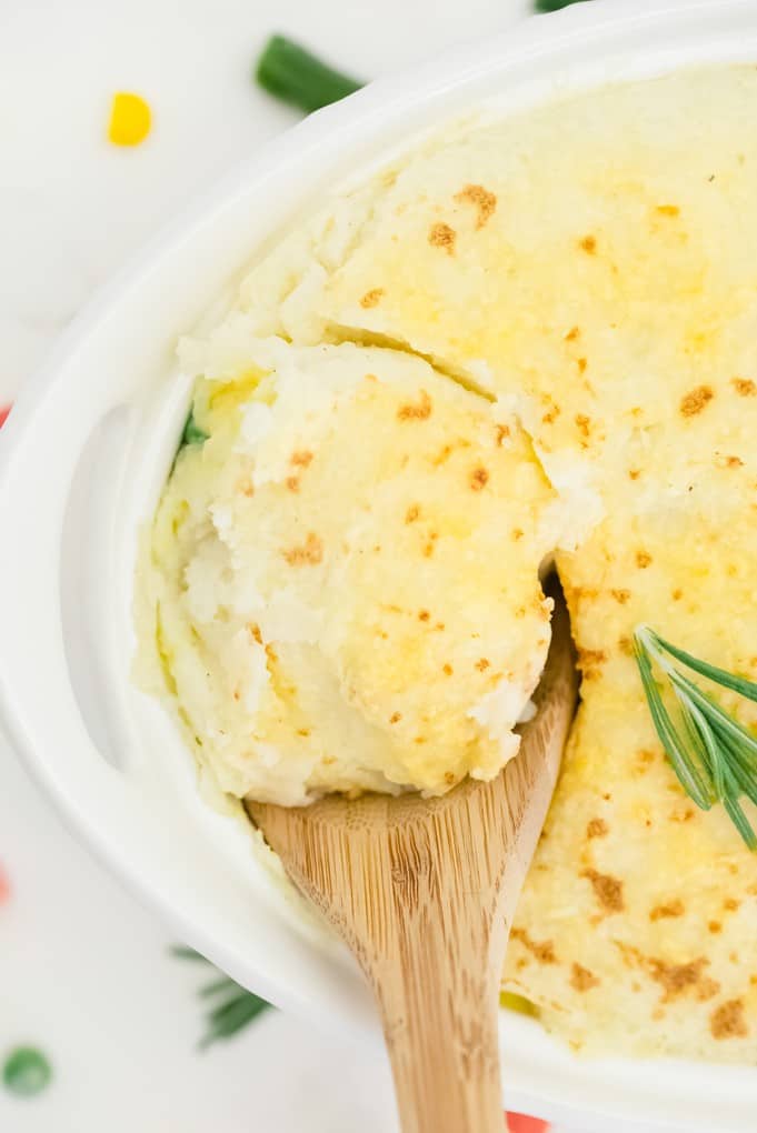 Chicken Shepherd's Pie - Not your mama's Shepherd Pie! This version is made with a creamy curry sauce that is out of this world. Topped with a heavenly layer of mashed potatoes and Parmesan cheese, this comfort food recipe will not last long. Mmm good.