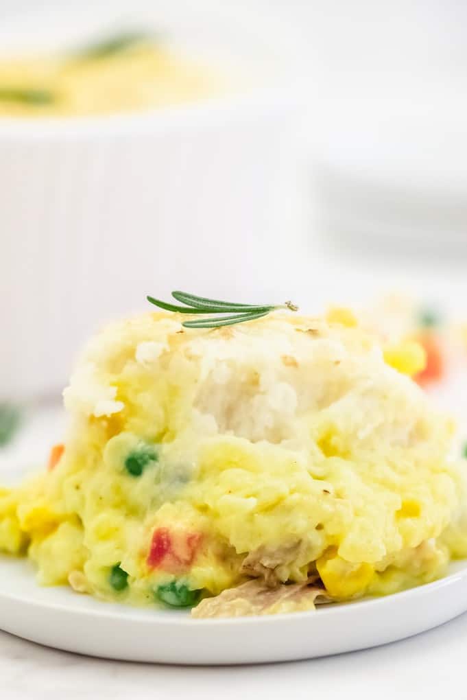 Chicken Shepherd's Pie - Not your mama's Shepherd Pie! This version is made with a creamy curry sauce that is out of this world. Topped with a heavenly layer of mashed potatoes and Parmesan cheese, this comfort food recipe will not last long. Mmm good.