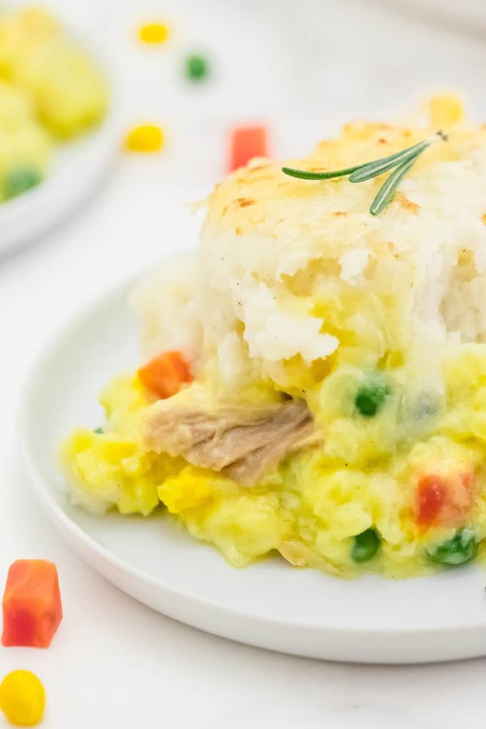 Chicken Shepherd's Pie - Not your mama's Shepherd Pie! This version is made with a creamy curry sauce that is out of this world. Topped with a heavenly layer of mashed potatoes and Parmesan cheese, this comfort food recipe will not last long. Mmm good.